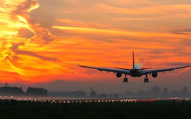 takeoff-of-a-passenger-plane-on-the-background-of-a-sunset-picture-id1125702176